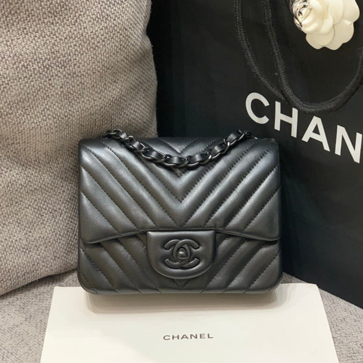 MINI BOLSO CUADRADO CON SOLAPA 17 CM PIEL DE CORDERO NEGRA CHEVRON HERRAJES NEGROS