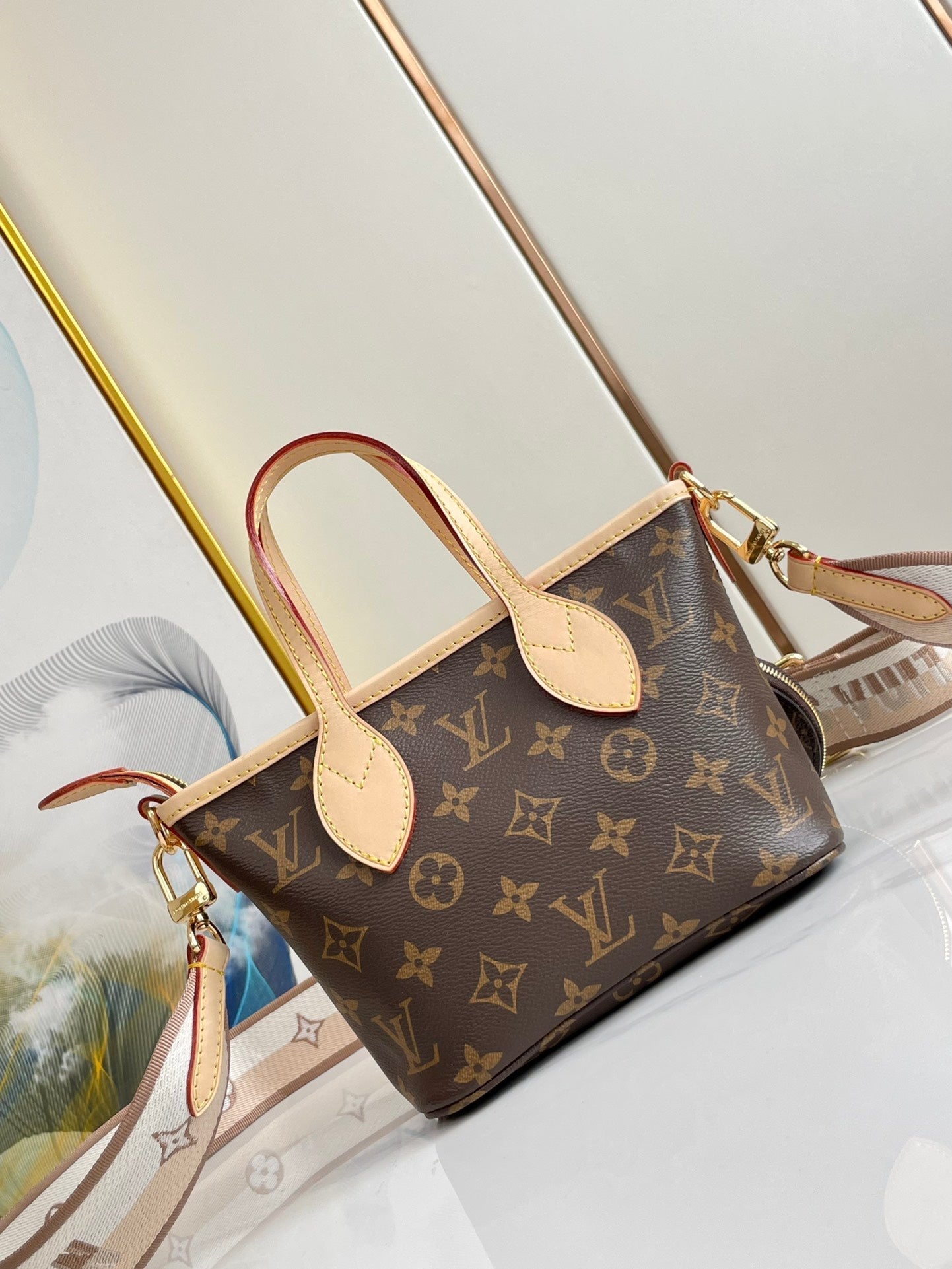 NEVERFULL BB 24 LONA CON MONOGRAMA MARRÓN Y ACABADOS DE CUERO, HERRAJES DORADOS