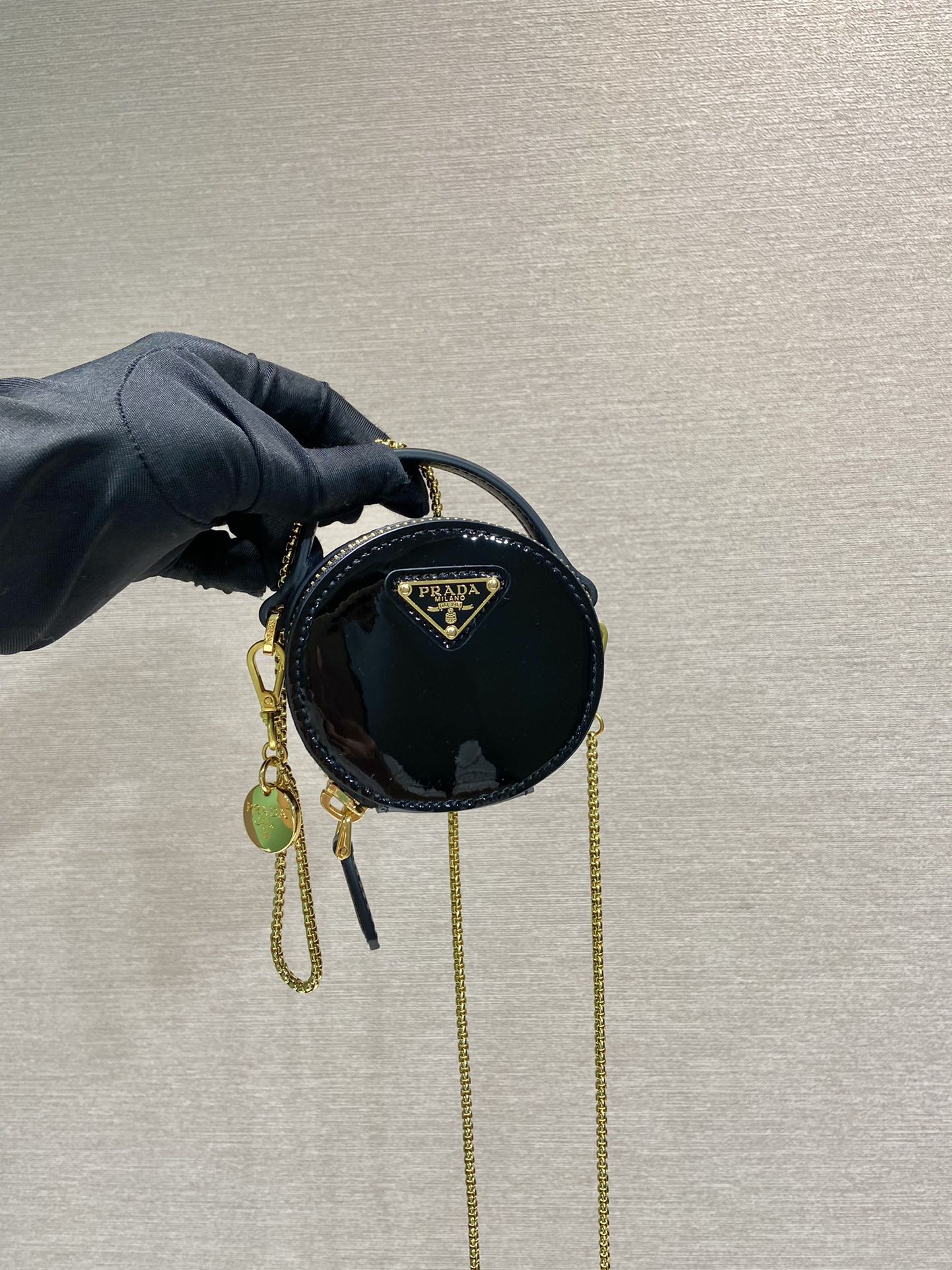 MINI BOLSO REDONDO 8 EN PIEL DE BECERRO NEGRA BRILLANTE CON HERRAJES DORADOS