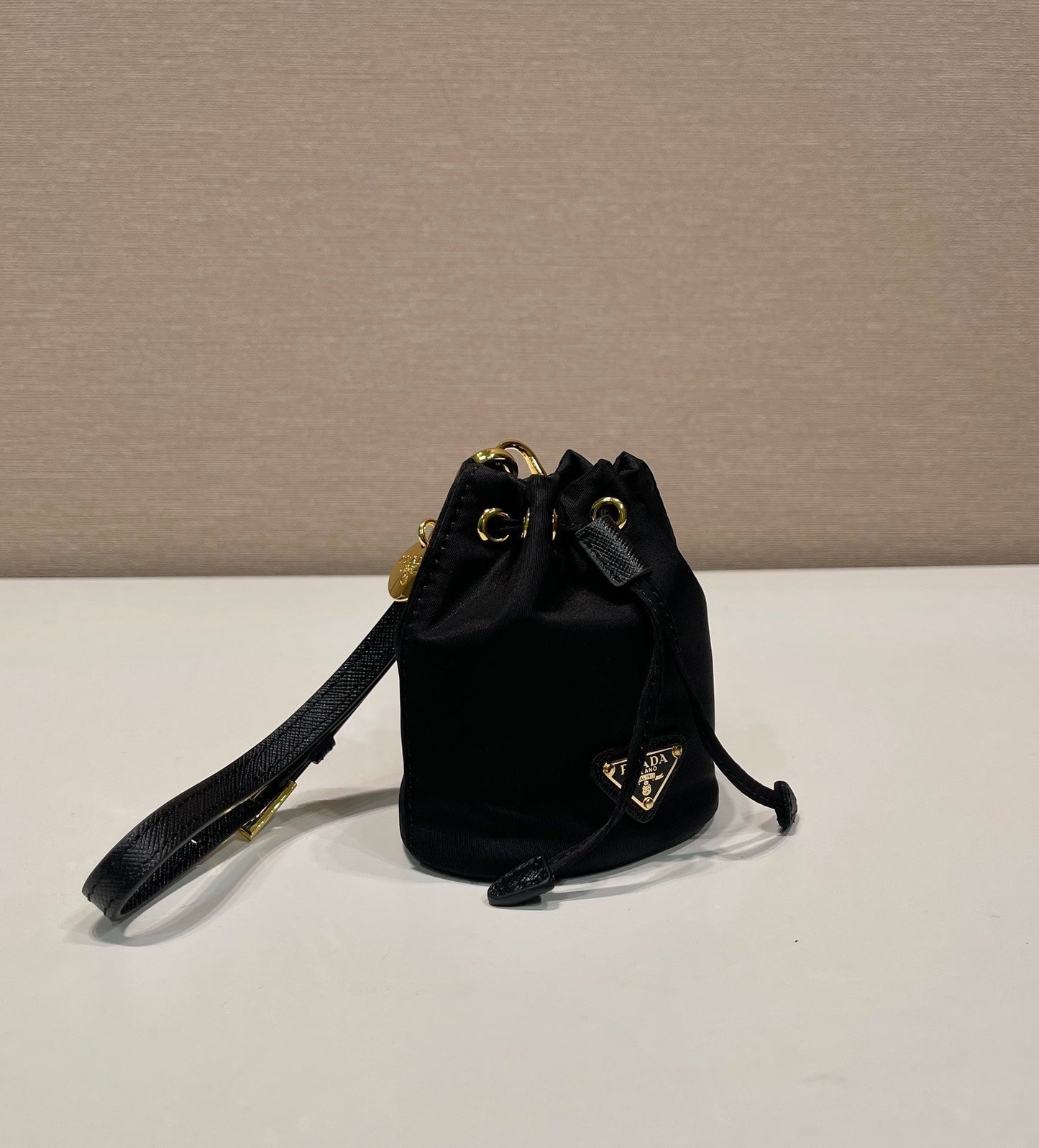 MINI BOLSO BUCKET 10 EN RE-NYLON NEGRO Y CORREA DE PIEL SAFFIANO