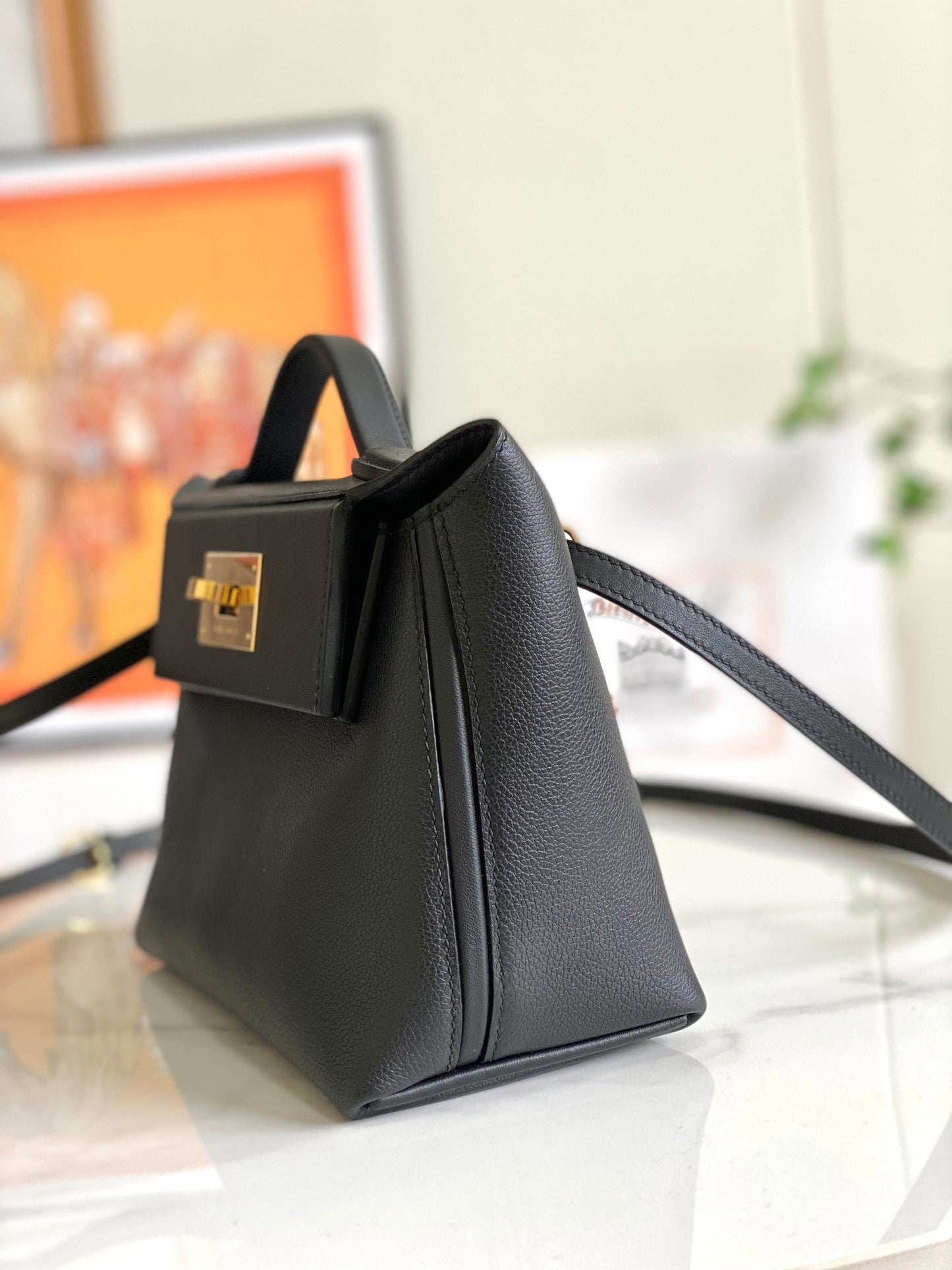 Bolso mini HM 24/24 de 21 cm, piel Evercolor negra, herrajes dorados