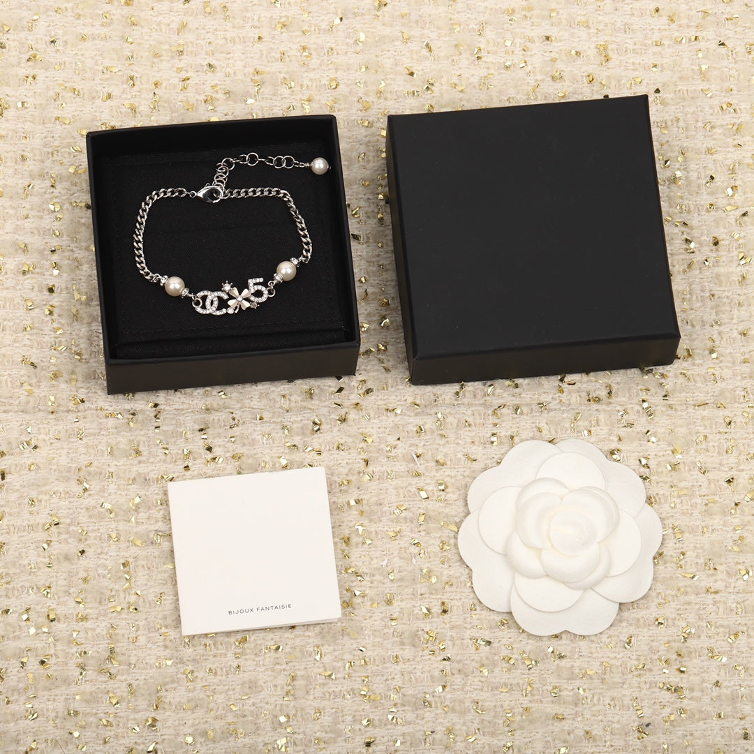 PULSERA DE PLATA MULTIELEMENTO DOBLE C