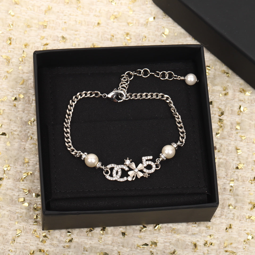 PULSERA DE PLATA MULTIELEMENTO DOBLE C