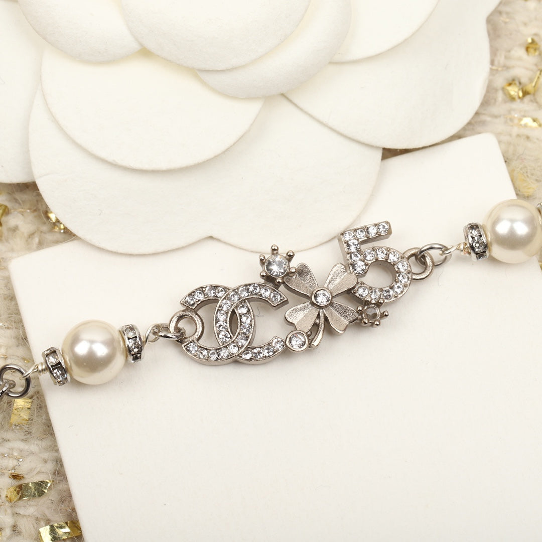 PULSERA DE PLATA MULTIELEMENTO DOBLE C