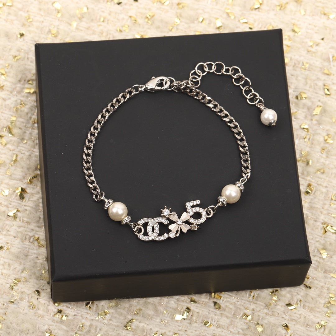 PULSERA DE PLATA MULTIELEMENTO DOBLE C