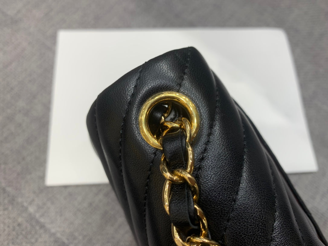 MINI BOLSO CUADRADO CON SOLAPA DE 17 CM EN PIEL DE CORDERO NEGRA CON CHEURÓN Y HERRAJES DORADOS
