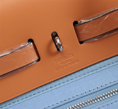 HM HERBAG ZIP 31 LONA CIELO Y BRONCE