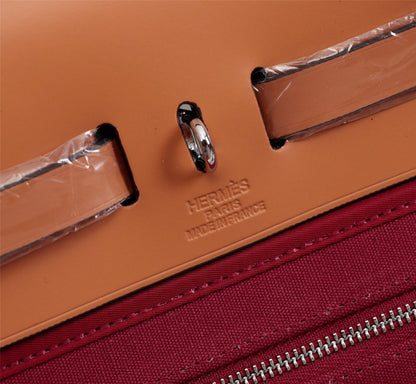 HM HERBAG ZIP 31 LONA ROJO VINO Y COBRE