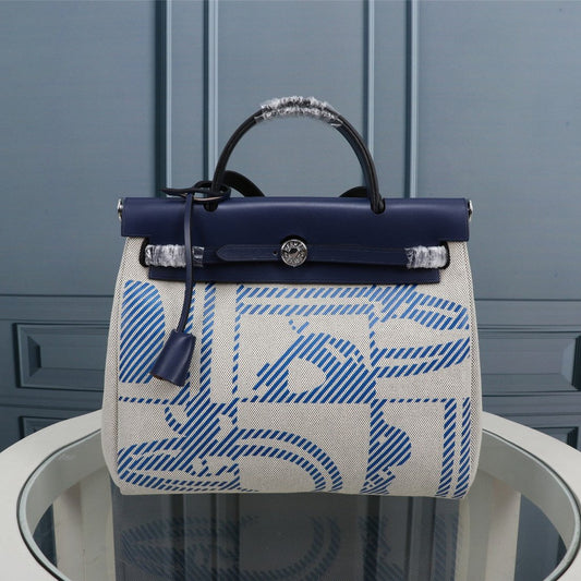 HM HERBAG ZIP 31 LONA CON MONOGRAMA AZUL MARINO Y CREMA
