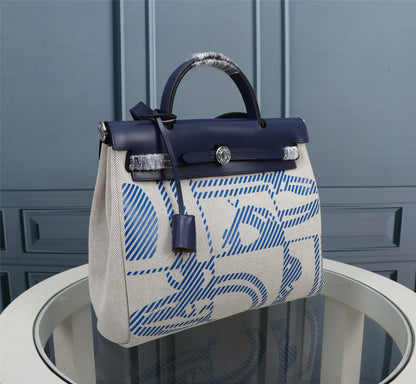 HM HERBAG ZIP 31 LONA CON MONOGRAMA AZUL MARINO Y CREMA