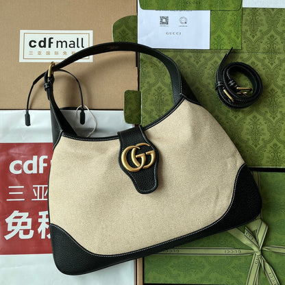 BOLSO MEDIANO APHRODITE 39 DE LONA BEIGE Y PIEL DE BECERRO NEGRA CON HERRAJES DORADOS
