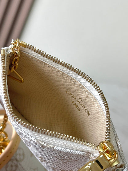 SEAU NANO 17 EN JACQUARD MONOGRAMME BLANC ET GARNITURE EN CUIR DE VEAU BEIGE