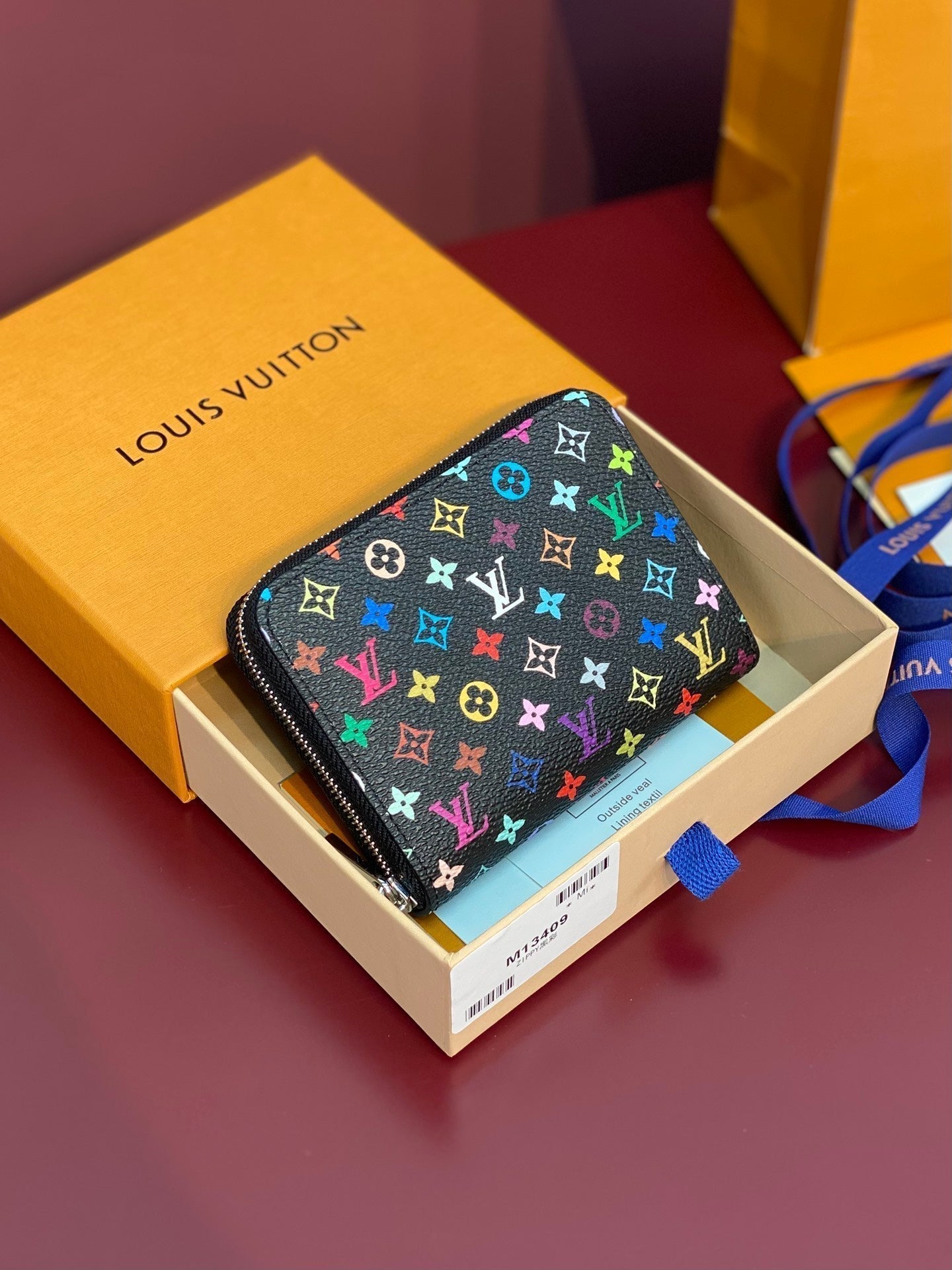 Monedero Zippy LV x TM de lona negra con monograma multicolor
