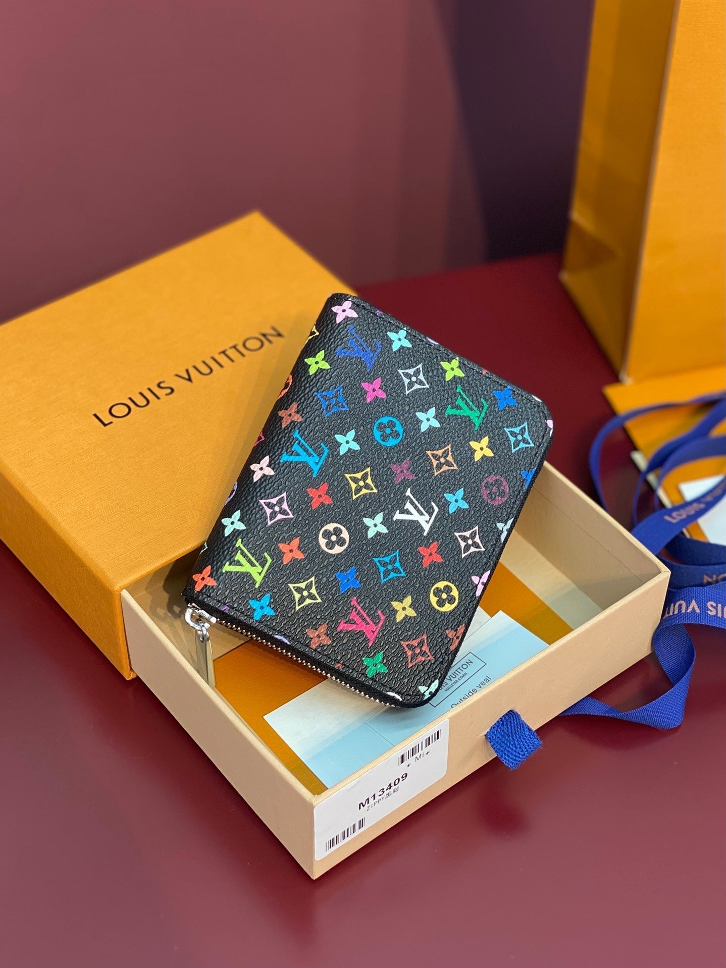 Monedero Zippy LV x TM de lona negra con monograma multicolor