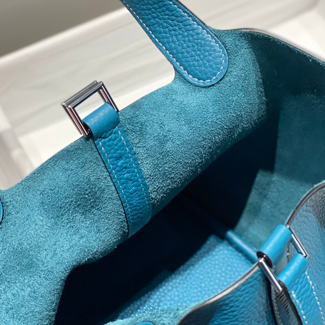 Cierre de picotina, jeans azules, cuero Togo, herrajes plateados