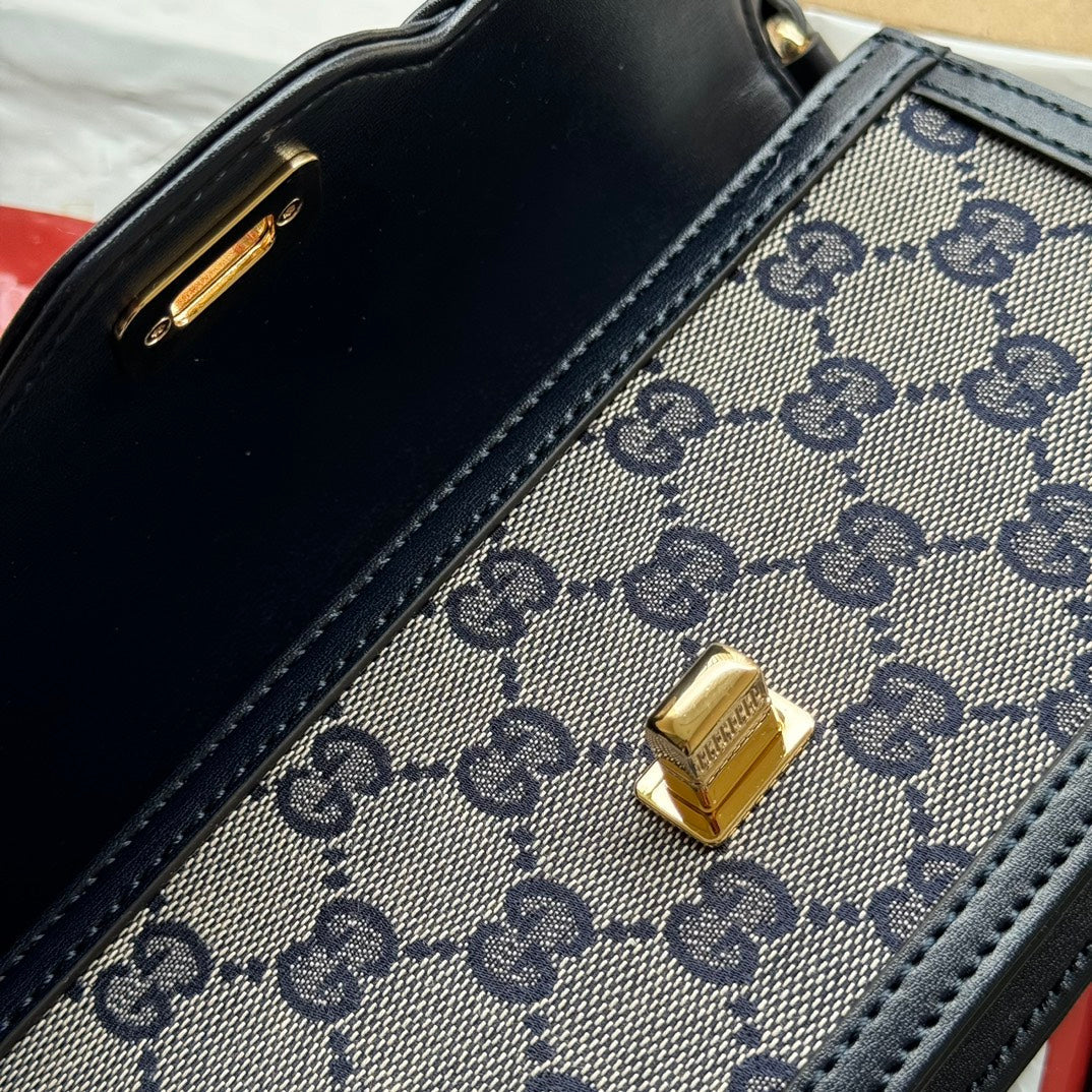 BOLSO DE HOMBRO LUCE MINI 20 EN LONA GRIS CLARO Y ADORNOS DE PIEL DE BECERRO NEGRA CON HERRAJES DORADOS