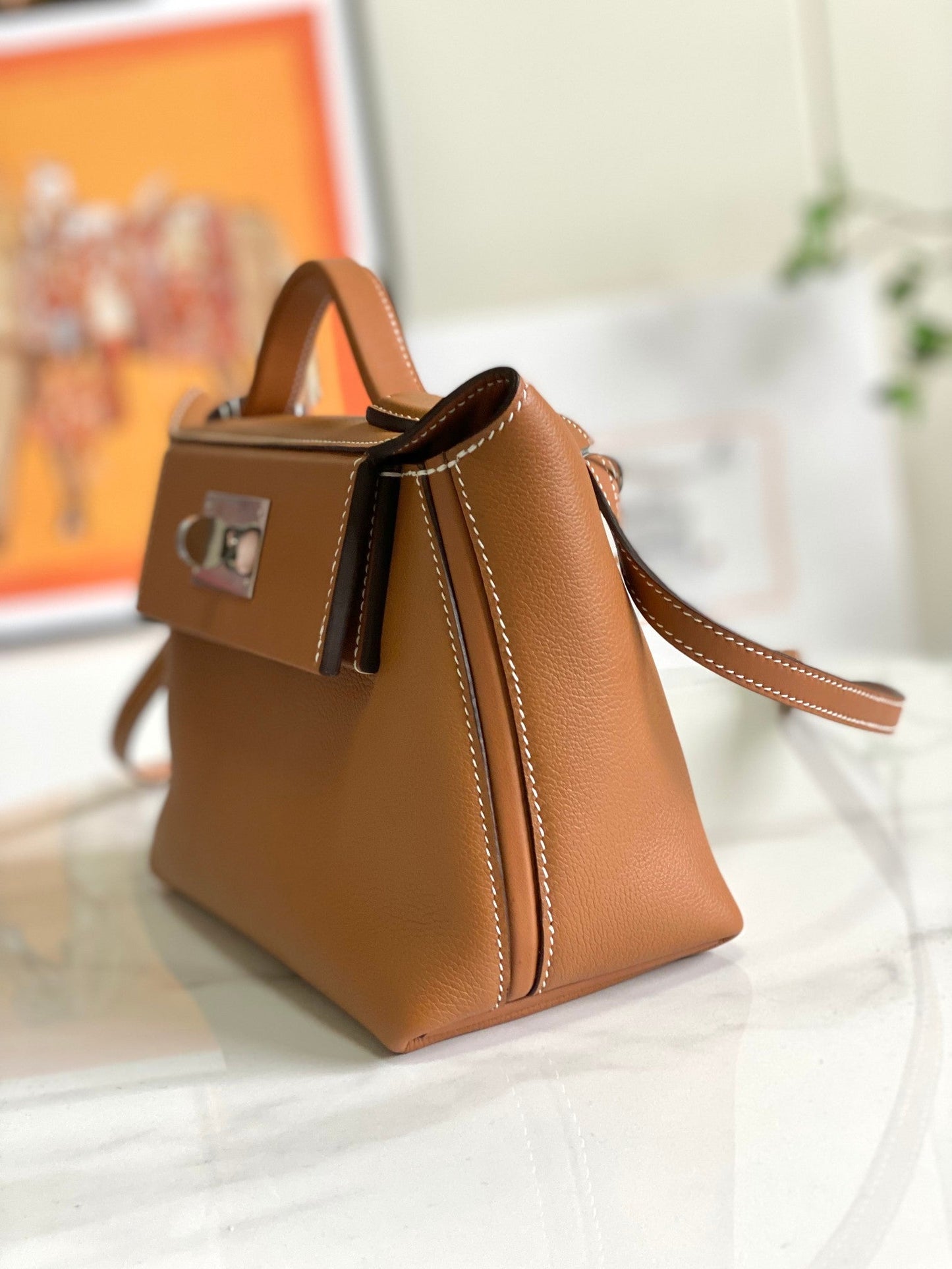 Bolso mini HM 24/24 de 21 cm, piel Evercolor dorada, herrajes plateados